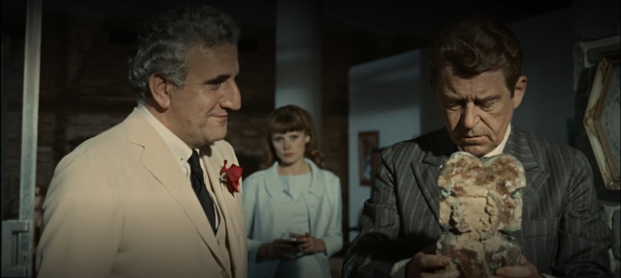 Adolfo Celi, Françoise Dorleac, and Jean Servais contemplate one of the statues